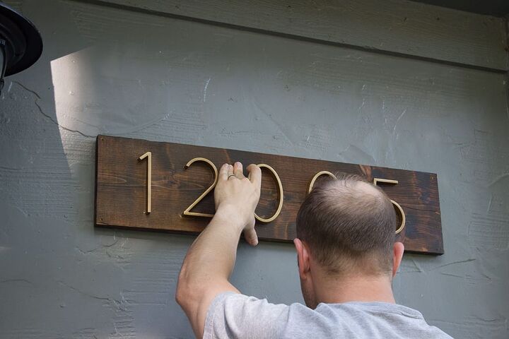 9 sleek house number ideas that ll turn heads on your block, Spay paint numbers gold stain a single board to get this sleek look in no time