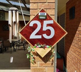 9 sleek house number ideas that ll turn heads on your block, Use a piece of plywood and a solar light to create this low maintenance beauty