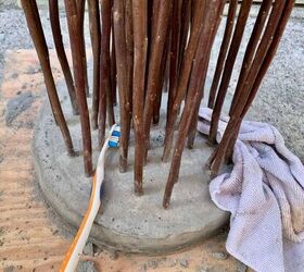 diy twig lights stand in a floating concrete base