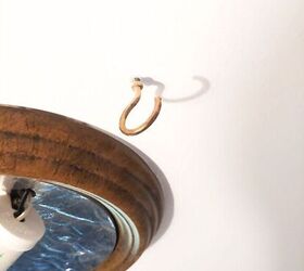 She hangs hooks around her light fixture for this stunning $7 upgrade
