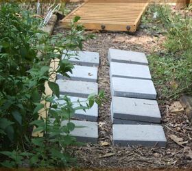 They stacked pavers under a bed frame to create a stunning garden accent