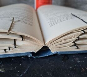 Turn old books into dramatic Halloween decor using bobby pins and plastic wrap