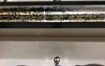 Get rid of dark spots on frame of bathroom mirror?