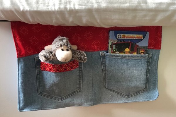 31 ideas that ll keep your home organized and looking good, How to Make a Bedside Pocket Organizer From Old Jeans