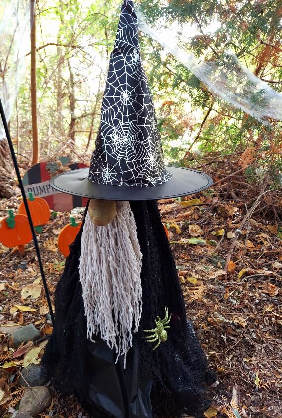 s 15 fun halloween ideas you can make on a dollar store budget, Create your own Halloween gnome using a tomato cage and a mop