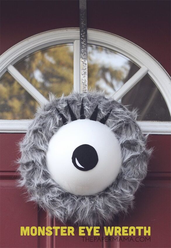 s 15 chic and spooky front door decor ideas for halloween, DIY a furry monster eye wreath for Halloween
