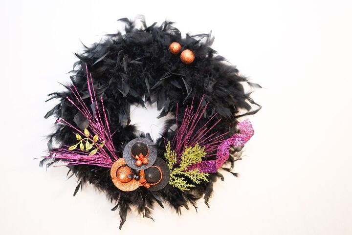 s 15 chic and spooky front door decor ideas for halloween, Make a sophisticated Halloween wreath from a feather boa