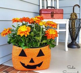 s 20 ways to turn thrifted items into charming fall decor, Turn an orange straw tote bag into a Jack o Lantern planter