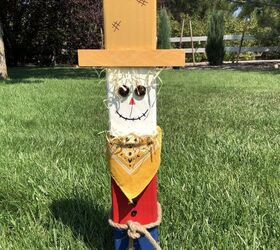 s 20 ways to turn thrifted items into charming fall decor, Dress up leftover fence posts into a scarecrow