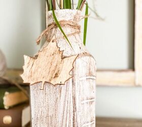 s 20 ways to turn thrifted items into charming fall decor, Upcycle an empty juice bottle into a rustic fall vase