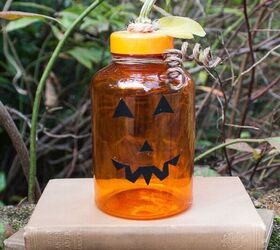 s 20 ways to turn thrifted items into charming fall decor, Make an adorable Jack o Lantern from an empty medicine bottle