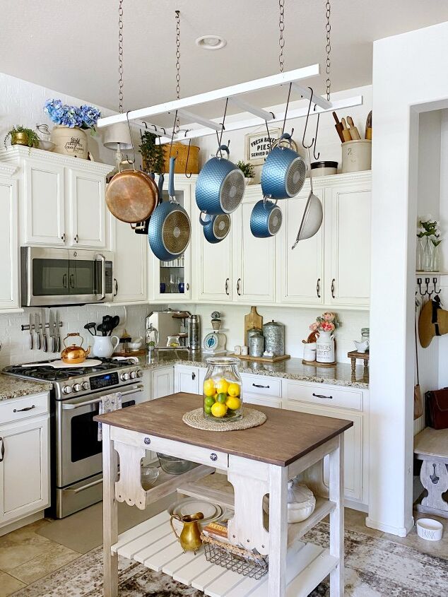 16 tricks that ll save you money on a full kitchen reno, Turn a ladder into a hanging pot rack