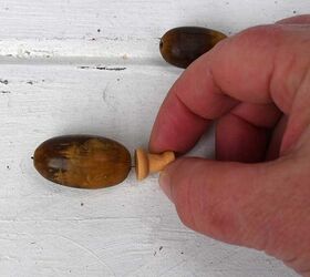 Poke a thumbtack through an acorn for this super cute decor