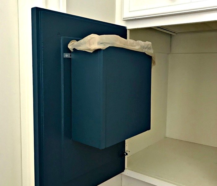 20 ways to boost bathroom storage without taking counter space, Build a garbage can on the back of your bathroom cabinet door