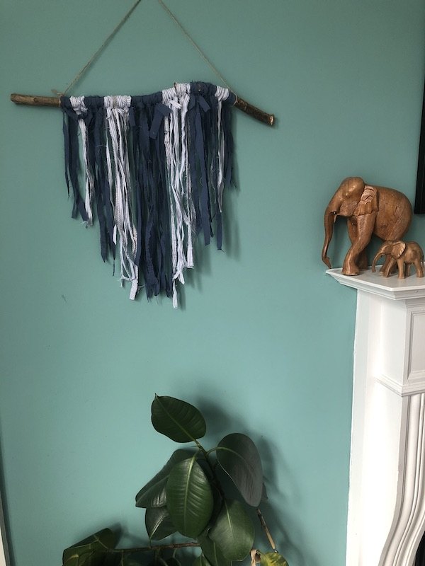 28 genius ways to reuse your old clothing, Upcycle worn out shirts into a macrame style wall hanging