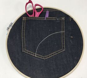 s 19 surprising ways to turn plain embroidery hoops into home decor, Stash your knickknacks in cute denim wall storage hoops
