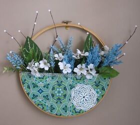 s 19 surprising ways to turn plain embroidery hoops into home decor, Add a touch of charm with a round floral pocket wreath