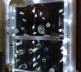 s replace your halloween porch decor with these 20 ideas, Jazz up your windows with sparkly hanging ornaments