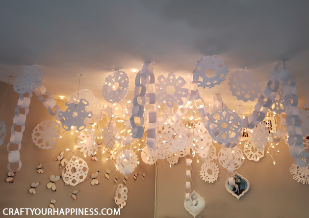 s 25 budget ways to make your home feel cozier this winter, Create a twinkly indoor winter wonderland with simple paper chains and snowflakes