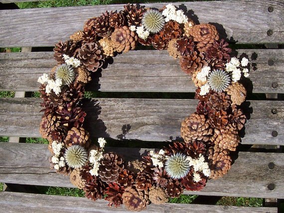 15 winter wreaths we re so ready to hang on our doors, DIY a natural pine cone wreath this winter