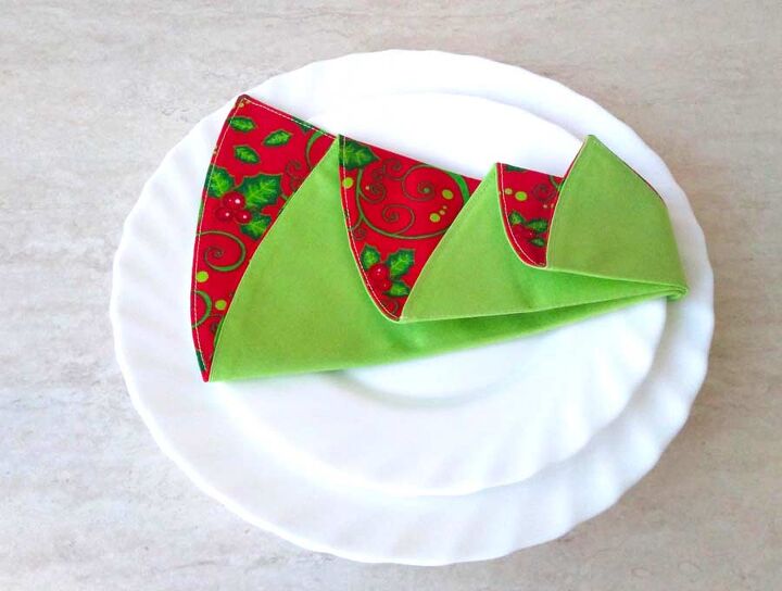 s 15 unexpected ways to sprinkle christmas cheer around your home, Dress up your table with reversible Christmas tree napkins