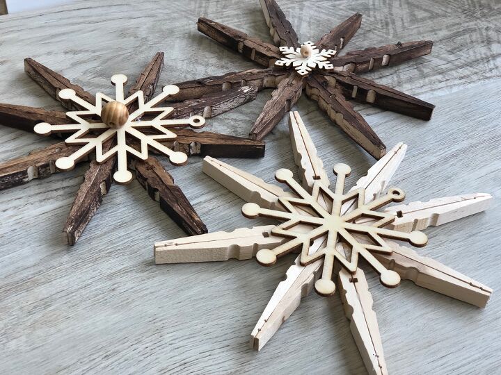 s 15 unexpected ways to sprinkle christmas cheer around your home, Repurpose wooden clothespins into rustic snowflake ornaments