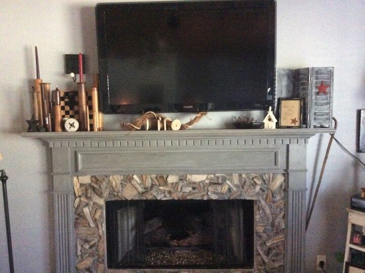 s 20 fireplace makeovers that will get your home in shape for the cold, Cover up fireplace tiles with pieces of petrified wood