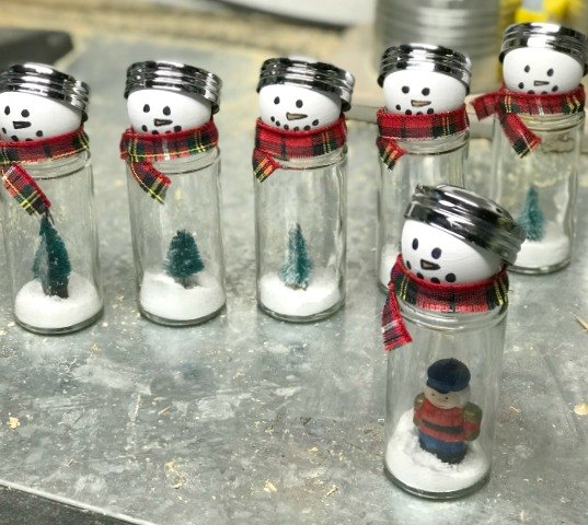 s 20 insanely cute snowmen that ll make it feel like winter, Repurpose glass spice containers into snow globe style snowmen