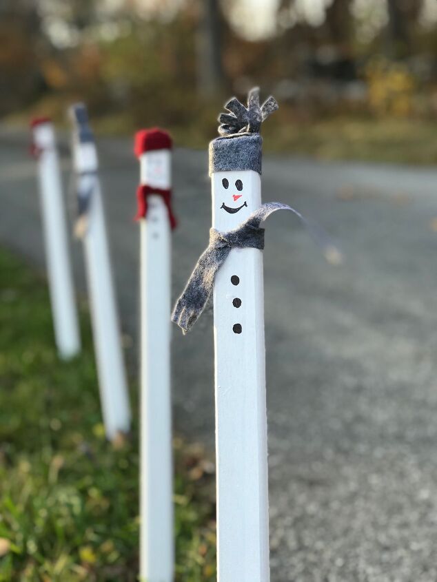 s 20 insanely cute snowmen that ll make it feel like winter, Plant these simple wood stake snowmen in your yard