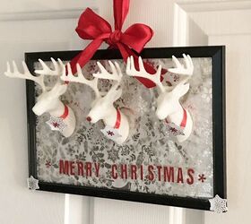 s 30 magical ways to make your home feel more merry and bright, Make festive wall art from plastic reindeers and a picture frame