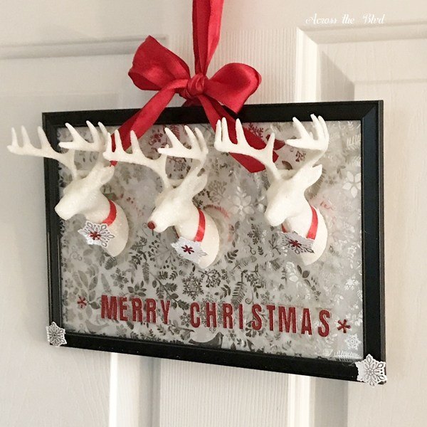s 30 magical ways to make your home feel more merry and bright, Make festive wall art from plastic reindeers and a picture frame