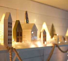 s 30 magical ways to make your home feel more merry and bright, Bring your home to life with a cozy Christmas village shelf