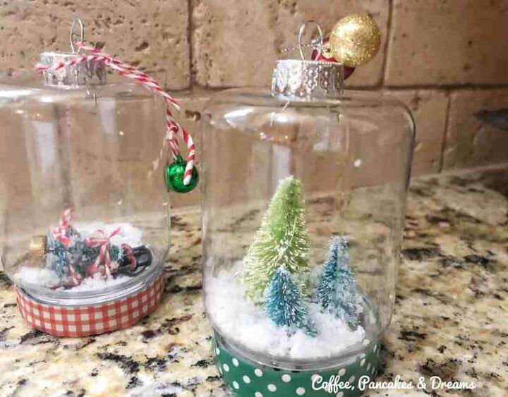 s 25 new christmas ornament ideas that we re totally obsessed with, Up your cute factor this Christmas with mini snow globe ornaments