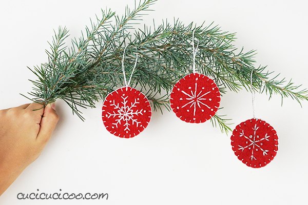 s 25 new christmas ornament ideas that we re totally obsessed with, Soften your tree with embroidered snowflake felt ornaments