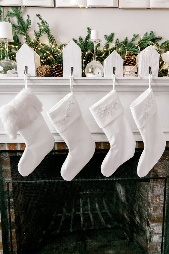 s 19 gorgeous ways to style your mantel for christmas, Decorate your mantle with DIY felt Christmas stockings
