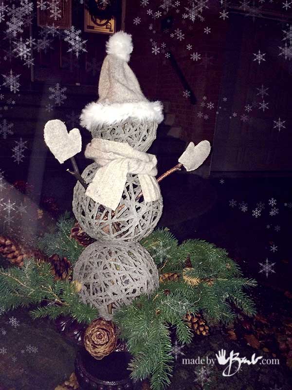 s 15 winter topiaries that will seriously impress your neighbors, Fill an empty planter with a snowman built from stunning concrete orbs