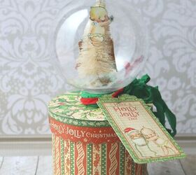 s 15 diy snow globes that make adorable decor and gifts, Top a Christmas gift box with a festive snow globe