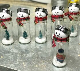 s 15 diy snow globes that make adorable decor and gifts, Repurpose glass spice containers into snow globe style snowmen