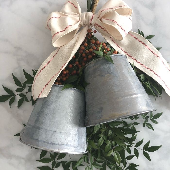 10 beautiful diy bells that will make your holiday home magical, Repurpose galvanized buckets into faux bell wreath