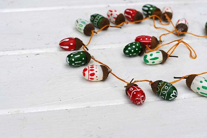 s 13 stunning garland ideas you should definitely try this year, String hand painted acorns together into a fun colorful garland