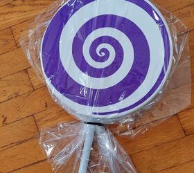 how to make diy giant lollipop decorations for a candyland christmas, Wrapping the lollipop with a shrink tight gift bag