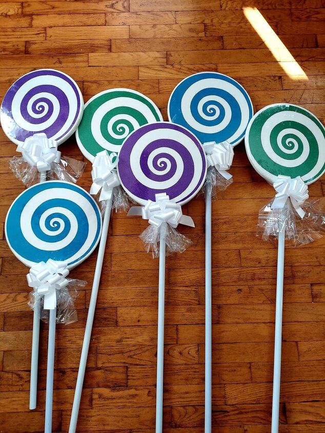 how to make diy giant lollipop decorations for a candyland christmas, Attach the bow to the lollipop