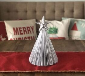 s 16 alternative christmas trees we re obsessed with this week, Upcycle a paperback book into a folded Christmas tree