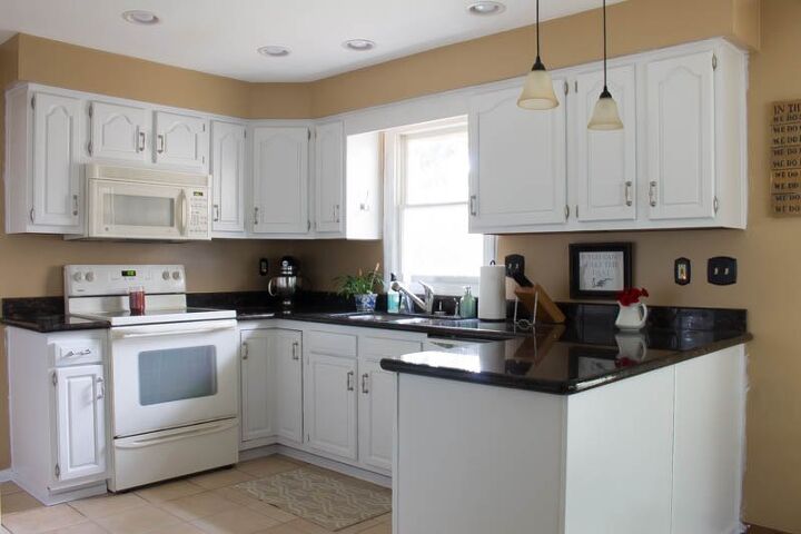 s 15 unique ways to make your kitchen cabinets more beautiful, Lighten up old oak cabinets with a white coat of paint