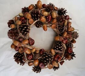 15 gorgeous ways to decorate your door after new year s, Celebrate winter s natural beauty with an acorn and pinecone wreath