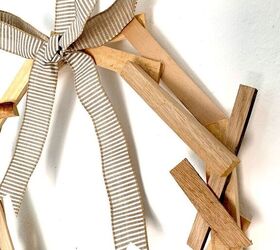 15 gorgeous ways to decorate your door after new year s, Make a rustic yet modern wreath from wood shims