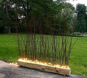 s 10 strange but stunning diys that blew us away this year, DIY a glowing privacy fence using IKEA branches and fairy lights