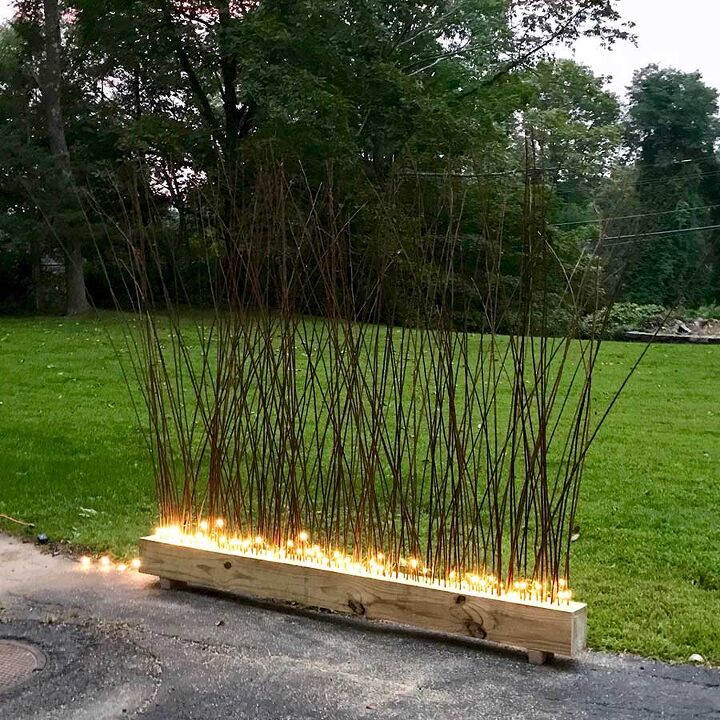 s 10 strange but stunning diys that blew us away this year, DIY a glowing privacy fence using IKEA branches and fairy lights