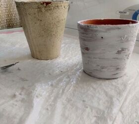 how to make aged clay pots using dollar store spackle, Smoothing the dollar store spackle on the clay pot