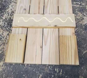 how to make easy diy board and batten shutters, Paint sticks as spacers and scrap wood as a guide while gluing and nailing the cross pieces on